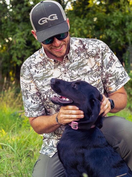 GameGuard Digital Original Shirt-GameGuard - man playing with dog outdoors in the woods wearing camo shirt