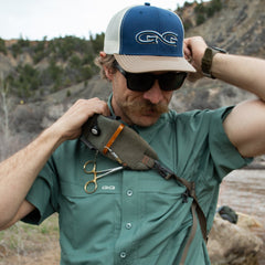 Ironwood Explorer Shirt-GameGuard - man putting on backpack to go fishing outdoors 