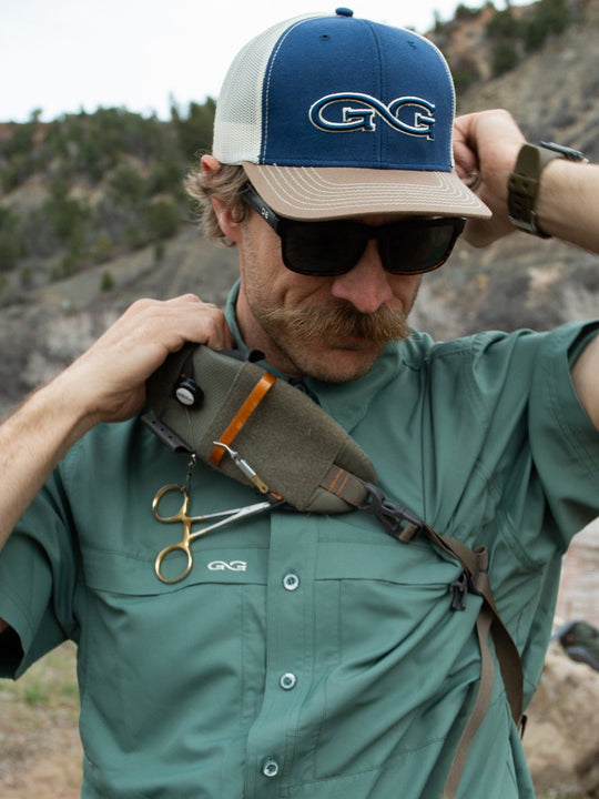 Ironwood Explorer Shirt-GameGuard - man putting on backpack to go fishing outdoors 