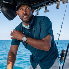 Oceanic Explorer Shirt-GameGuard- man fishing and driving a boat wearing lightweight and cool UPF 50+ protection shirt