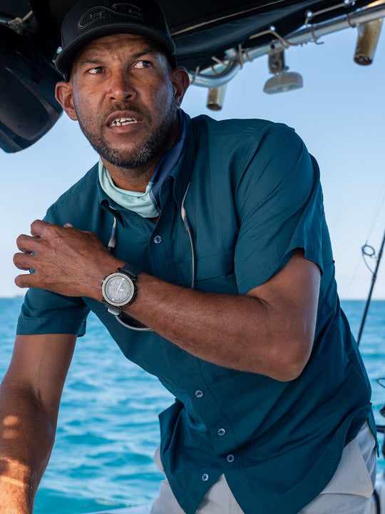 Oceanic Explorer Shirt-GameGuard- man fishing and driving a boat wearing lightweight and cool UPF 50+ protection shirt