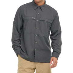 Man wearing a dark gray long-sleeve outdoor button-up shirt with tan pants against white background.