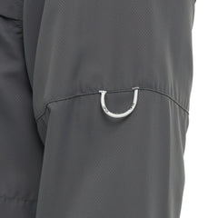 Close-up of utility loop detail on sleeve of dark gray outdoor performance shirt.
