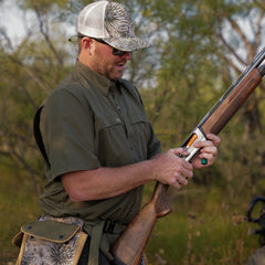 Agave Original Shirt-GameGuard- man loading shotgun while hunting in the woods blending in with the dark green look
