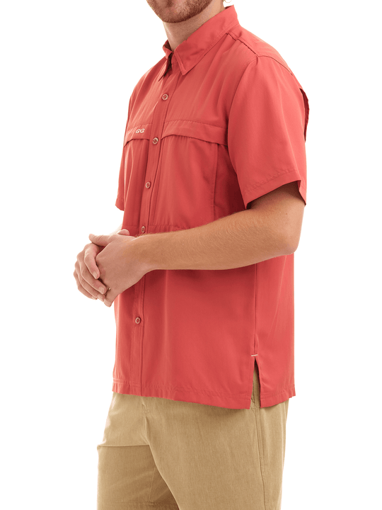 Man wearing a red shirt and beige pants on a white background