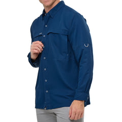 Man wearing Deep Water blue GameGuard Original long sleeve shirt with mesh vents, roll-up sleeves, GG logos, and utility loop; made for fishing and sun protection.