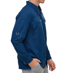 Man wearing Deep Water blue GameGuard Original long sleeve shirt with mesh vents, roll-up sleeves, GG logos, and utility loop; made for fishing and sun protection.