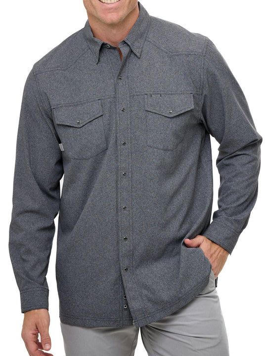 Man wearing Caviar GameGuard Pearl Snap Shirt with long sleeves, flap chest pockets, snap closures, and western yoke; classic rugged style for ranch or town.