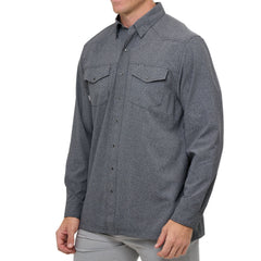 Man wearing Caviar GameGuard Pearl Snap Shirt with long sleeves, flap chest pockets, snap closures, and western yoke; classic rugged style for ranch or town.