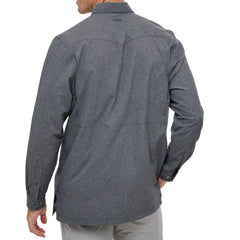Man wearing Caviar GameGuard Pearl Snap Shirt with long sleeves, flap chest pockets, snap closures, and western yoke; classic rugged style for ranch or town.