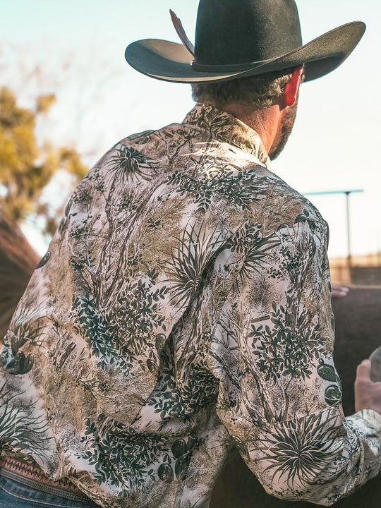 GameGuard Explorer Shirt | Long Sleeve-GameGuard - man brushing horse in the outdoors wearing GameGuard camo, built to blend into the southwest enviornment during a hunt and maintaining durability while working